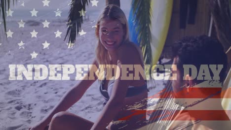 Animation-of-independence-text-banner-over-caucasian-couple-talking-to-each-other-at-the-beach