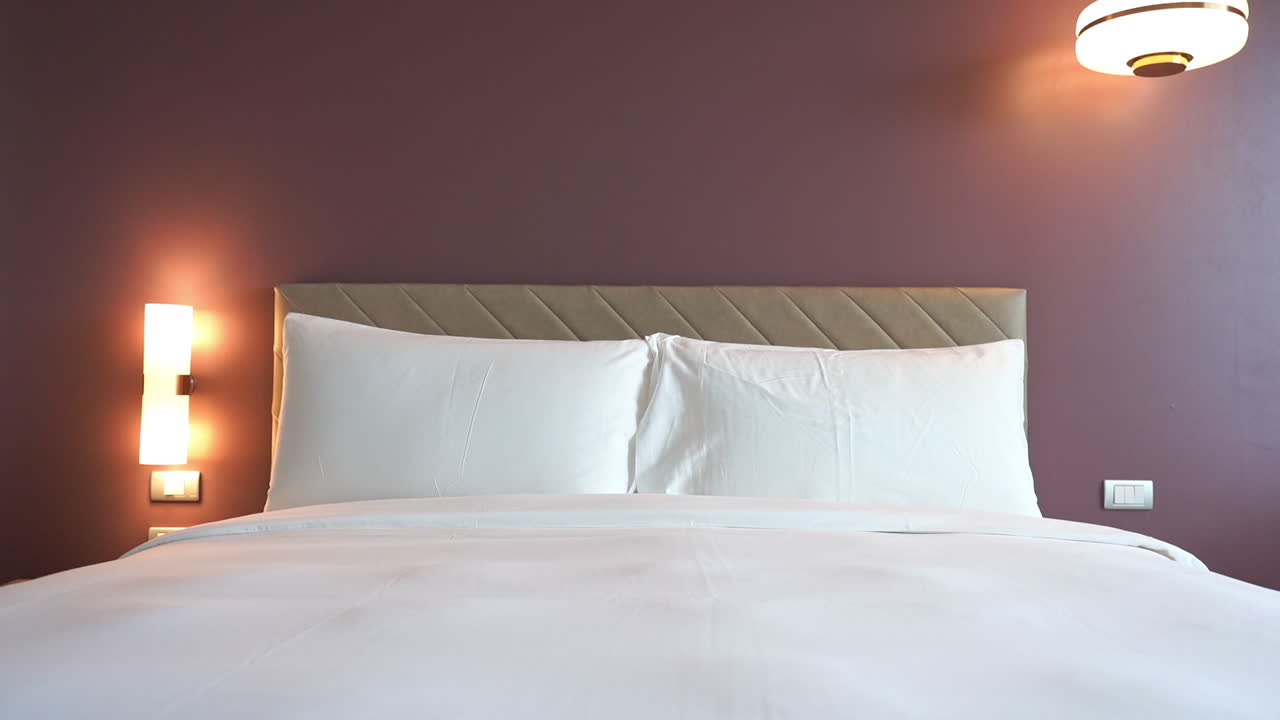Tilt-down from wall to the foot of a hotel suite bed