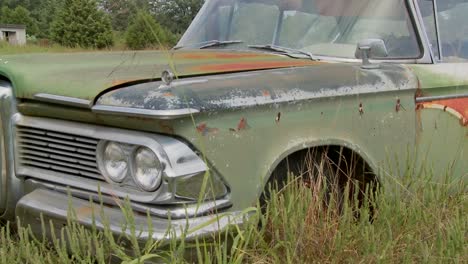 an old ford edsel sits in a field 3