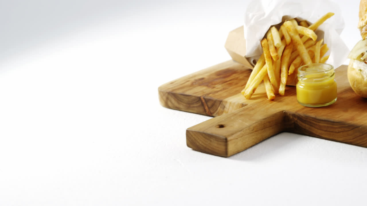 Snacks with dip on chopping board