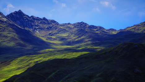 lush green valley surrounded by majestic mountains under blue sky