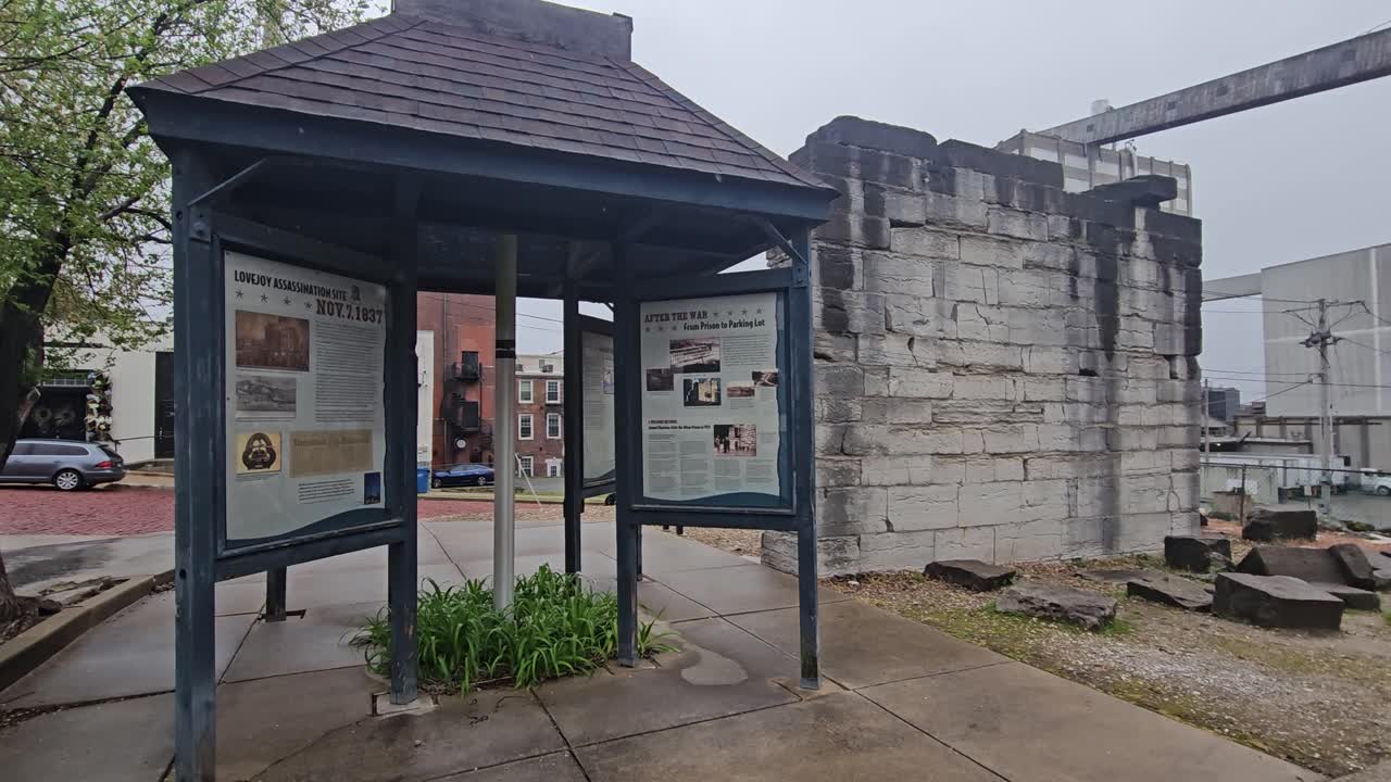 Benjamin Godfrey Historical Site with Ruins of the First State Prison Wall with Informational Boards and Ardent Flour Mill in the Background.