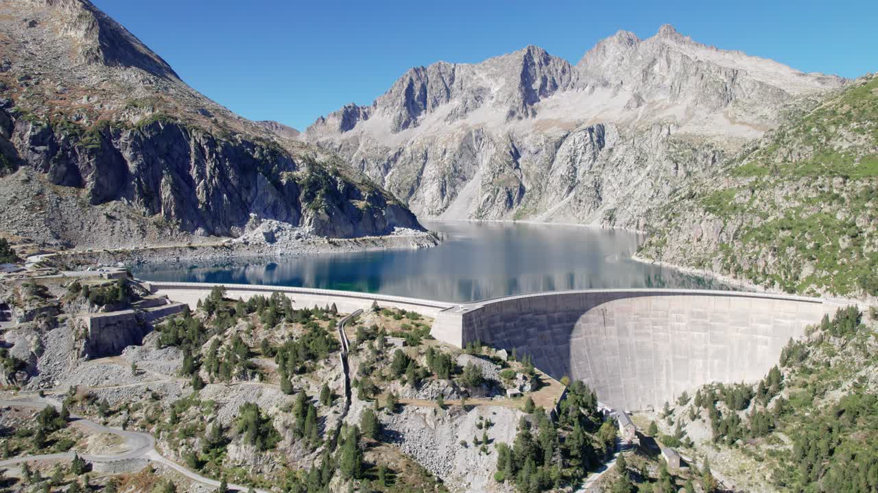 Large hydroelectric dam producing clean and green energy from cap de long reservoir in a beautiful French Pyrenees mountain landscape