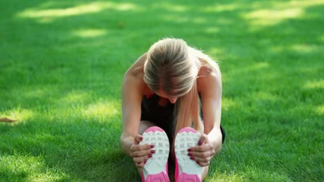 sport woman training stretching exercise in summer park. fitness woman warm up