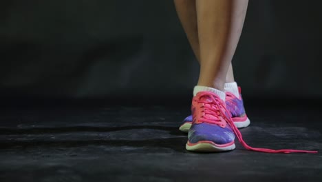 closeup of a girl ties shoelaces