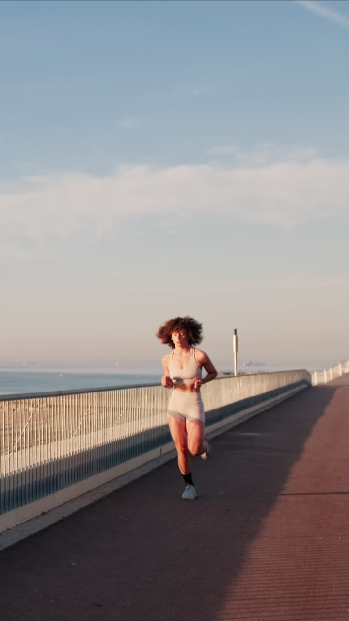 Woman Running By The Sea At Sunrise