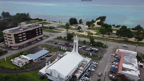 Drone-aerial-view-of-church-with-ocean-in-background