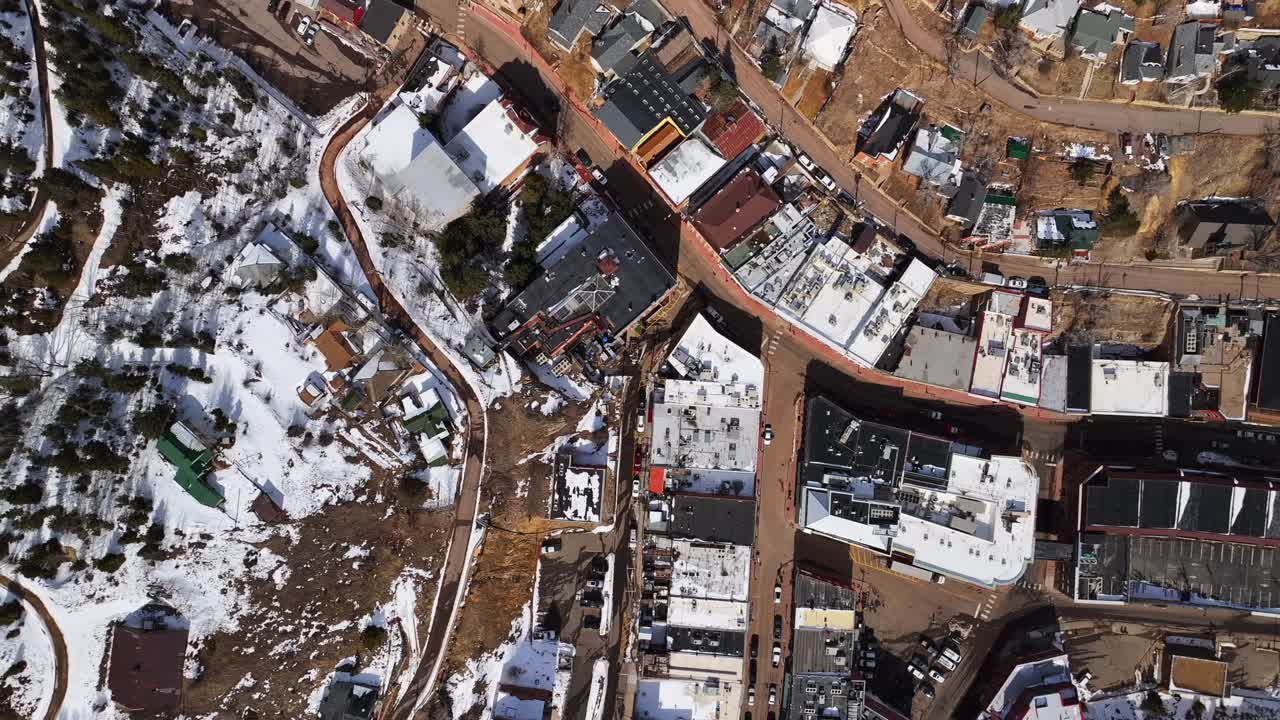 Snowy historic downtown Idaho Springs Central City Blackhawk Casino's Birdseye view sunny winter day snow aerial drone Colorado Gilpin County Gold mine Rocky Mountains buildings mountains upwards