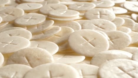 communion hosts sacramental breads turning round rotating flat lay top view