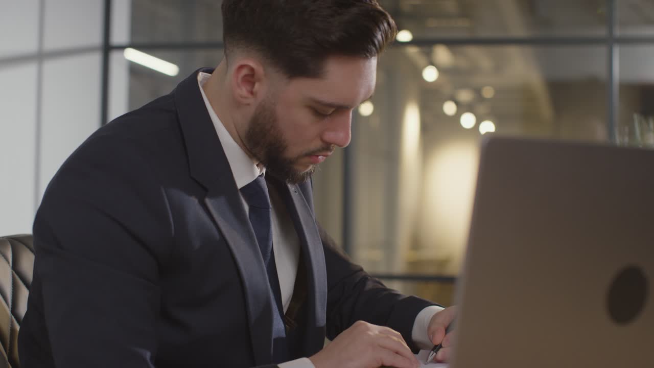 Close Up Of Businessman In Office Reviewing And Making Notes On Application Or CV For Job Vacancy 3