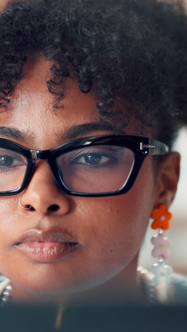 Close-up of Young Woman's Focused Eyes Wearing Glasses