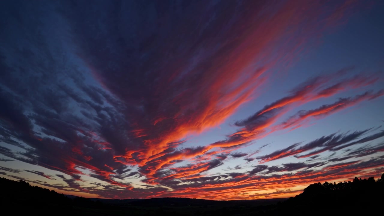 Dramatic Red and Orange Clouds in a Vibrant Sunset Sky