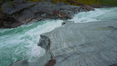 fast flowing river with grey rocks