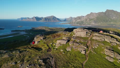 Viewpoint-at-Ryten-and-Kvalvika-Beach-hike-in-Lofoten-Islands,-Norway---Aerial-Pedestal