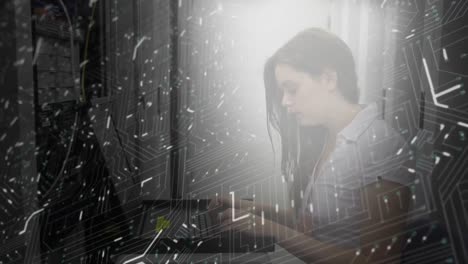 Woman-working-on-computer-server-while-glowing-motherboard-moves-in-foreground