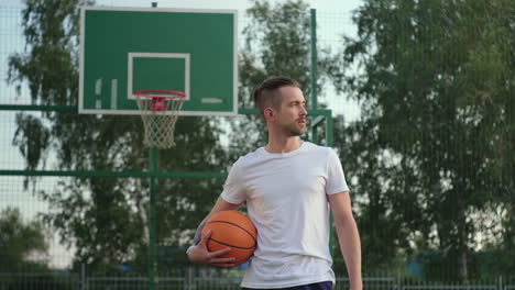 man holding basketball on court