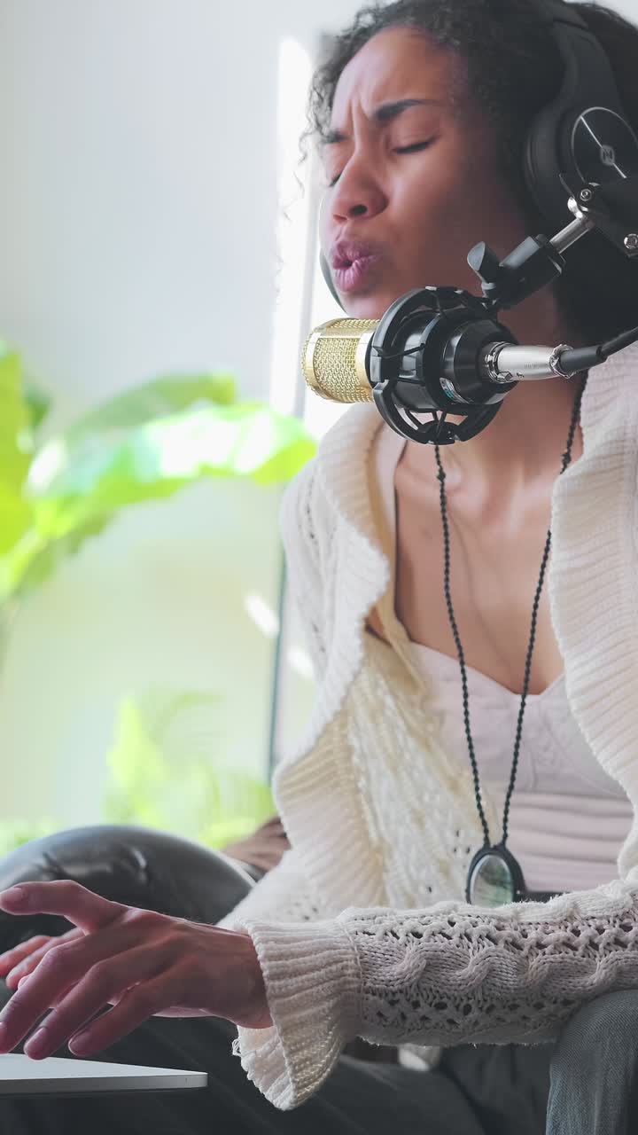 Young african american woman blogger leads video blog and speaks into microphone