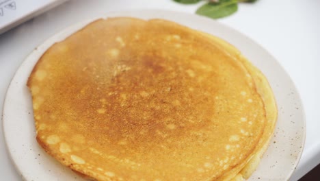 anonymous person putting a pancake on top of another pancake