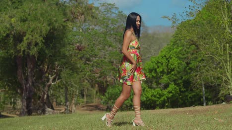 a young latina girl, dressed in a dress, enjoys herself in a caribbean park on trinidad island