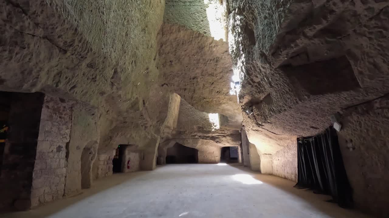 Tilt to skylight in underground tufa cave cellars of Maison Ackerman