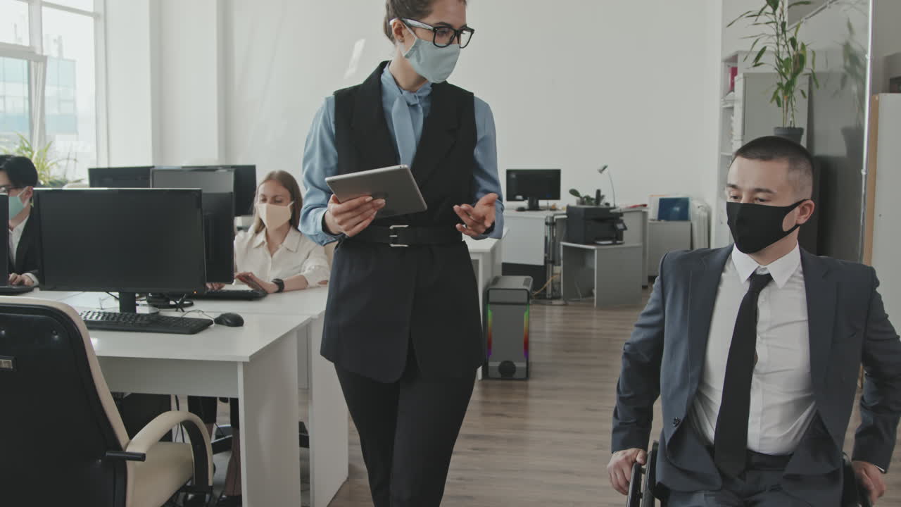 Businesswoman and Businessman Talking in Office