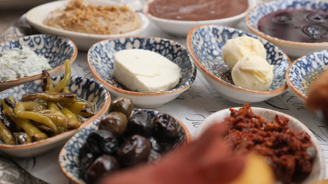 Breakfast spread with olives, cheese, peppers and various spreads