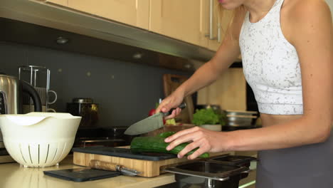 dolly in shot of female hands slicing cucumber