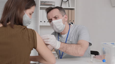 cheerful doctor giving vaccine injection