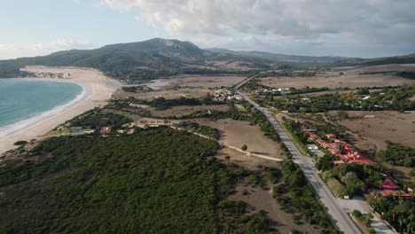 Drone-shot-of-the-Spain-coastline-with-the-E-5-highway-running-parallel