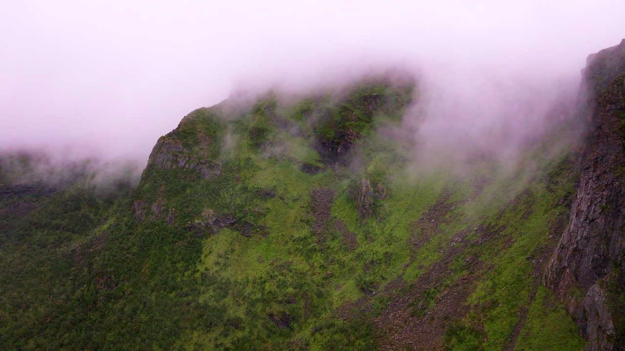 Mountains shrouded in mist and fog in Vesterålen, arctic landscape in northern Norway. Aerial drone