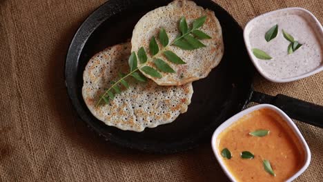 rotating set dosa is a 'set' of 2 dosas topped with butter or ghee and chutney on nice background