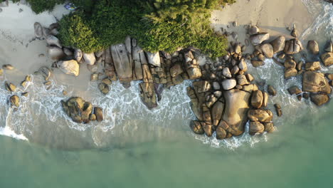 sunset drone aerial top down view of heavenly turquoise colored water brazilian beach, jurere internacional, florianopolis, santa catarina, brazil