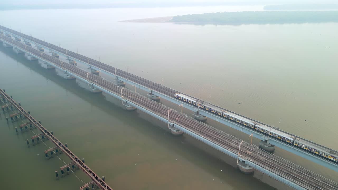 train going from naigoan to bhayandar on vasai creek bridge bird eye view