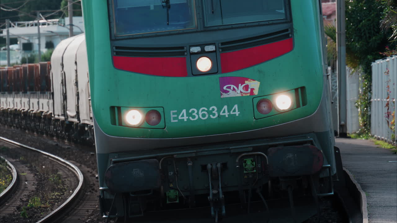 Nice, France - October 24, 2024: Close up of a green train moving on the rails near the station