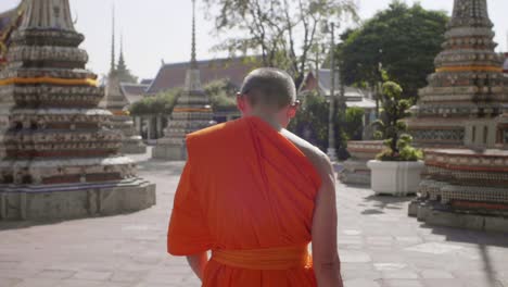 buddhist monk walking through temple