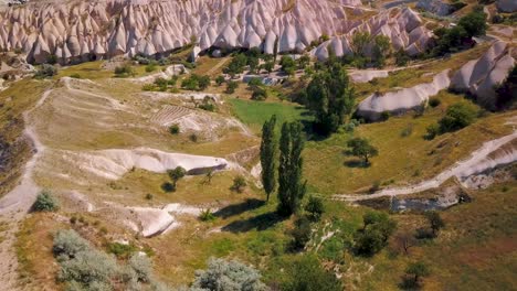 amazing, beautiful and unique mountain rock formations of uchisar by drone, cappadocia, turkey - aerial shot