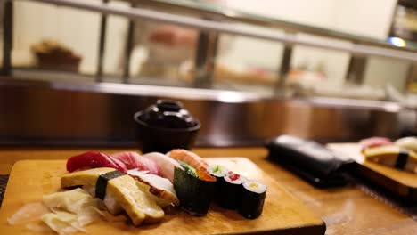 various sushi pieces displayed on wooden board