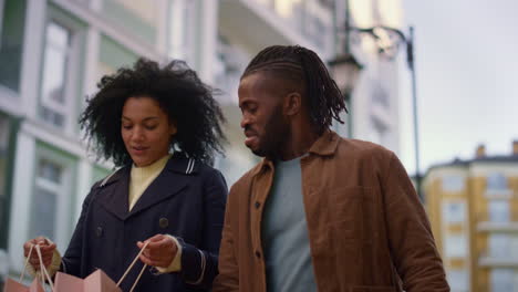 Cheerful-lovers-walking-city-street-together-portrait.-Adorable-smiling-couple.