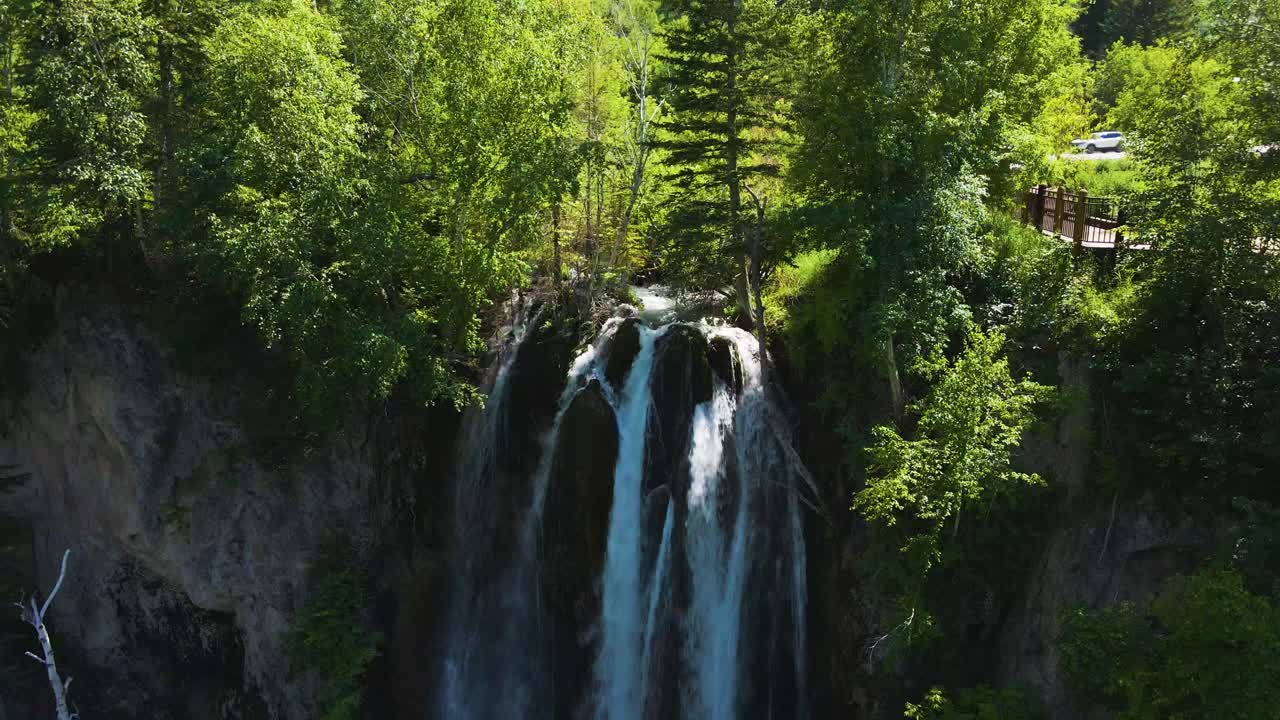 Aerial parallax shot of the rushing water of Spearfish Falls in Spearfish Canyon, South Dakota