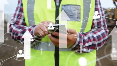 Network-of-profile-icons-and-arrows-against-mid-section-of-constructor-worker-using-smartphone
