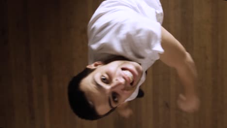 a guy jumping to try and grab the camera mounted on the ceiling - top view