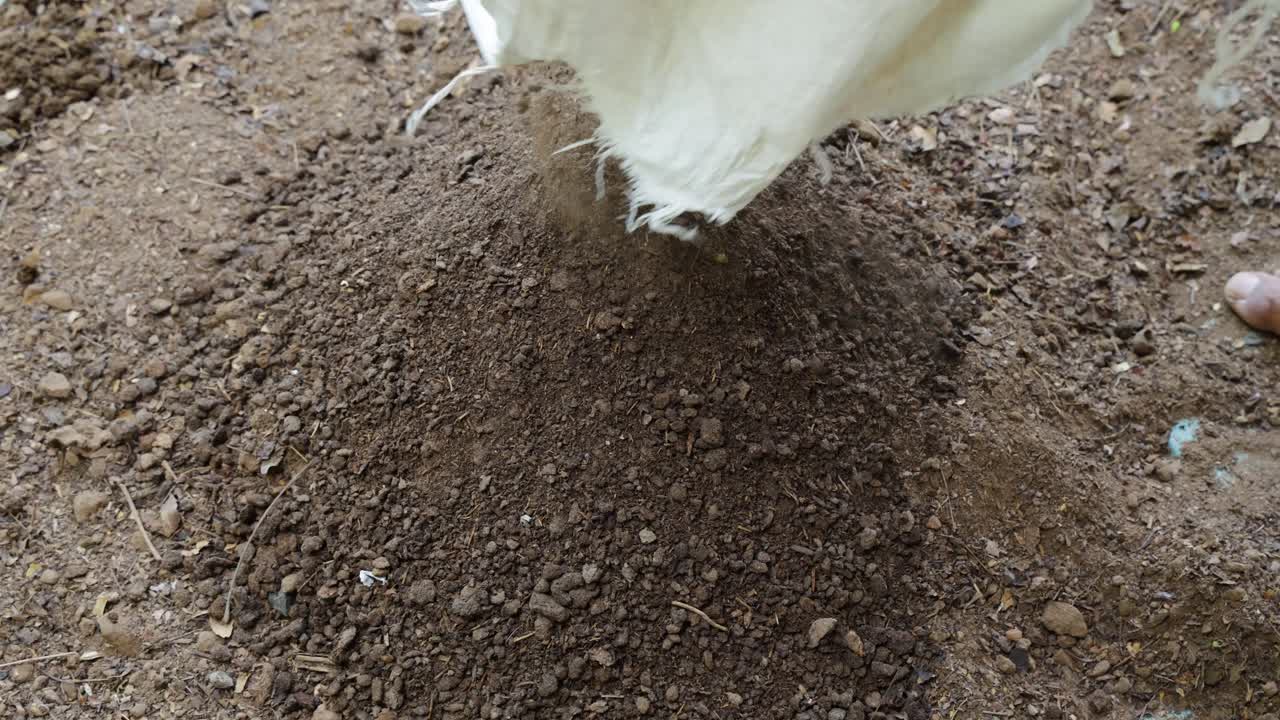 vermi compost mixing with garden soil for garden farming at outdoor