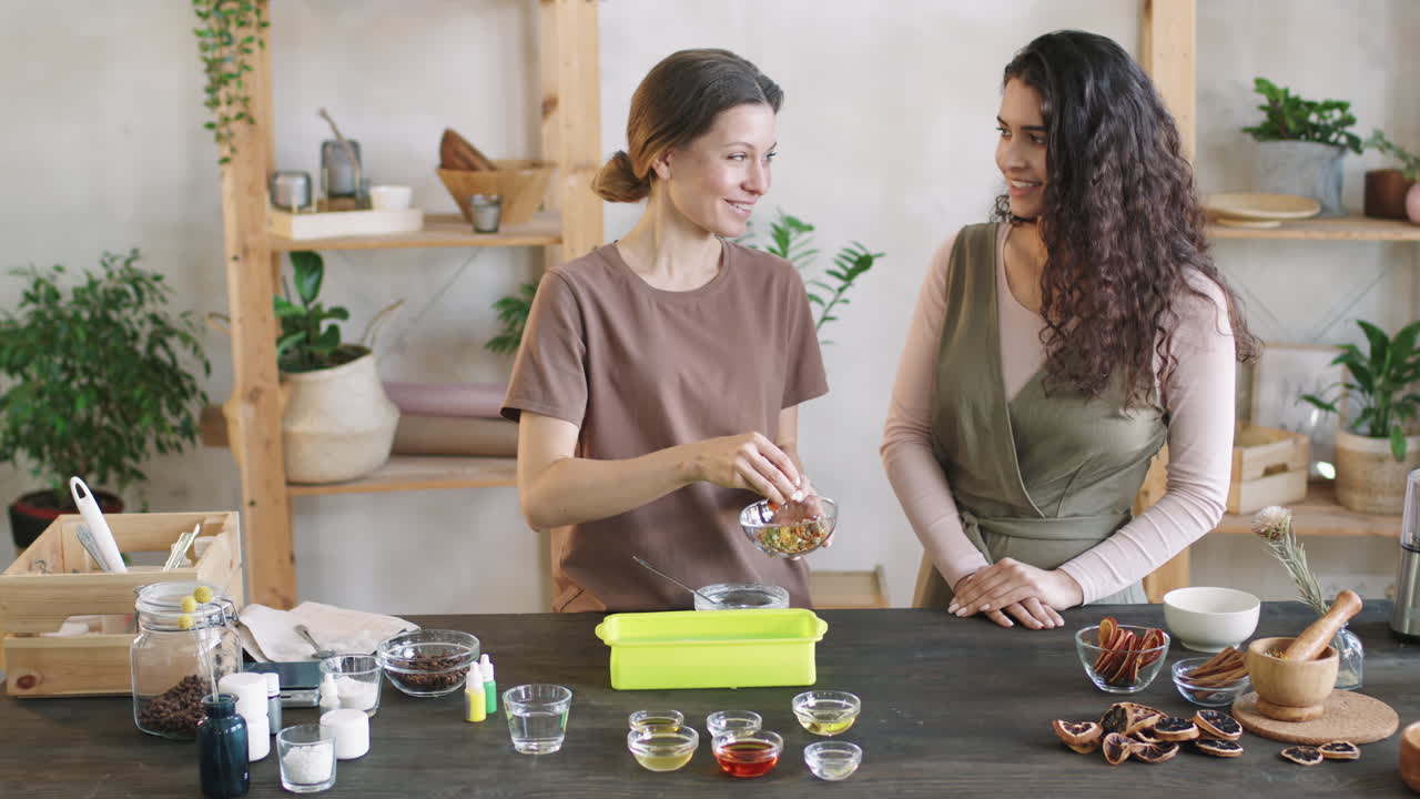 Women Decorating DIY Soap With Floral Petals