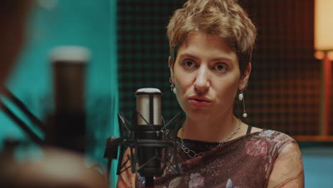 female podcast guest being interviewed in recording studio