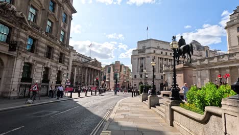 busy street with pedestrians and statue