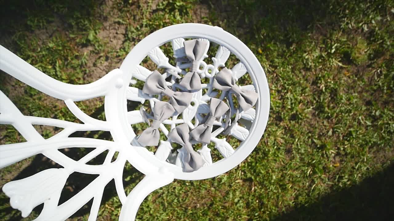 Gray satin bow tie on a wooden background. Accessory for formal dress. Symbol of elegance and fashion for men. Men's casual. Men's and women's bowtie