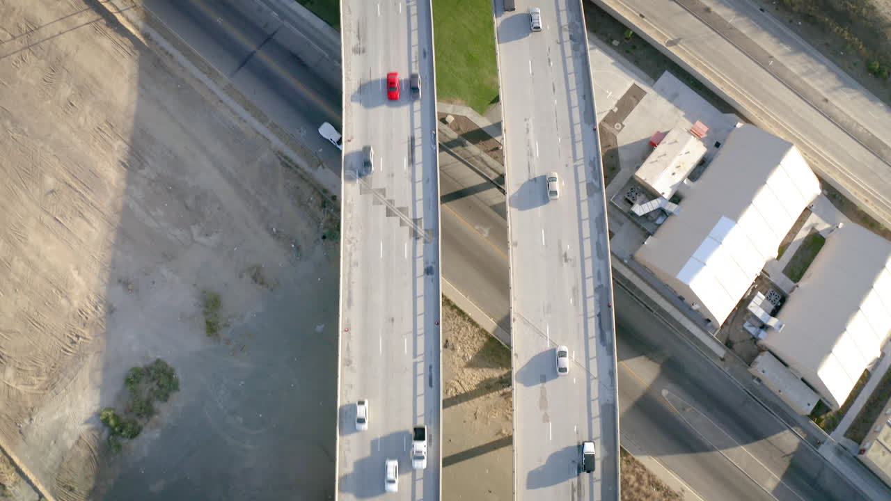 Aerial top-down view of cars driving on a highway overpass