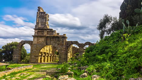 moving cloud time lapse of ancient tinadri greek theatre in italy shows a historical building ruins