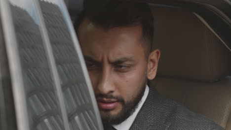 mixed-race man getting in car
