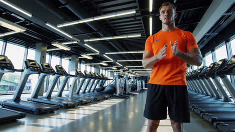 man demonstrating an exercise in a modern gym